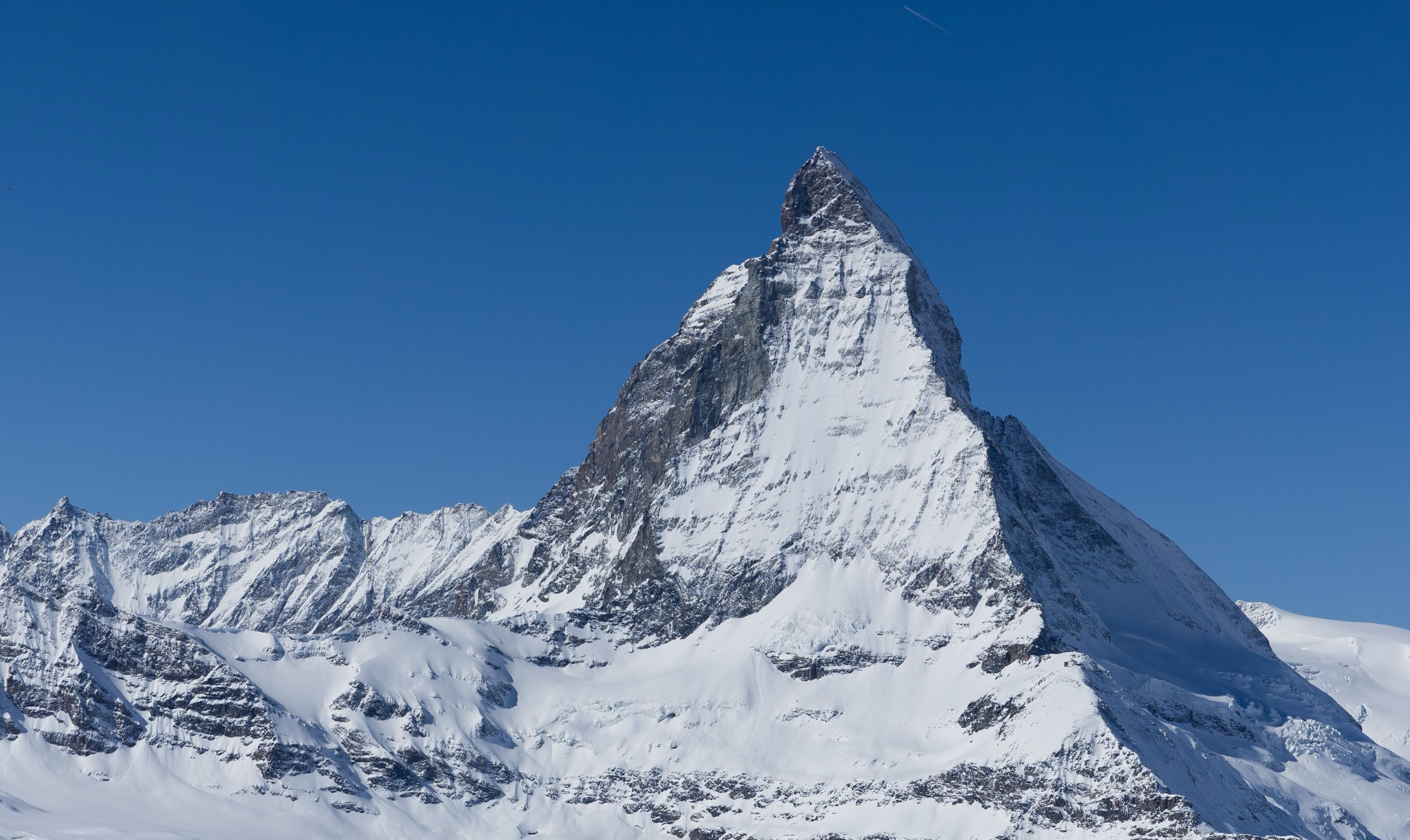 The Matterhorn, a snow-covered alpine peak against a blue sky