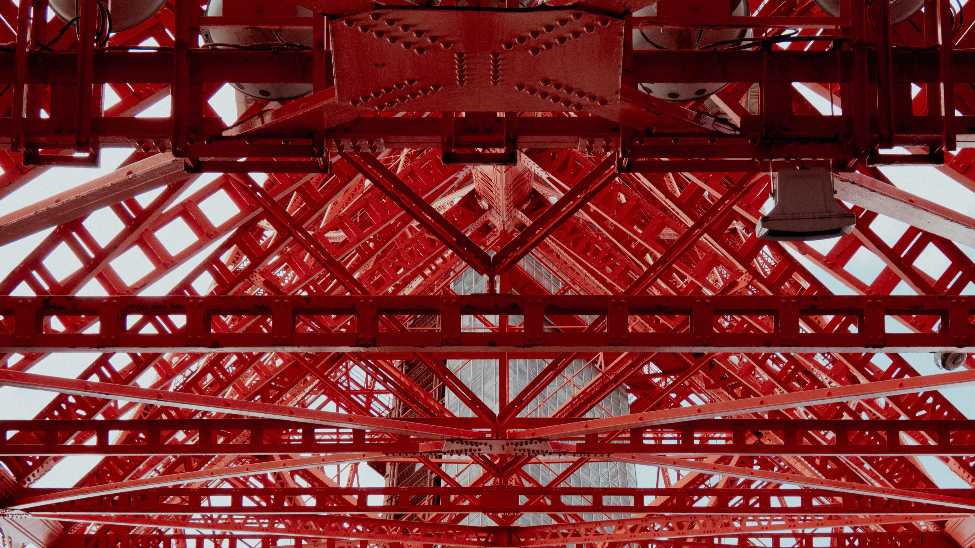 Red steel structure of a tower seen from below